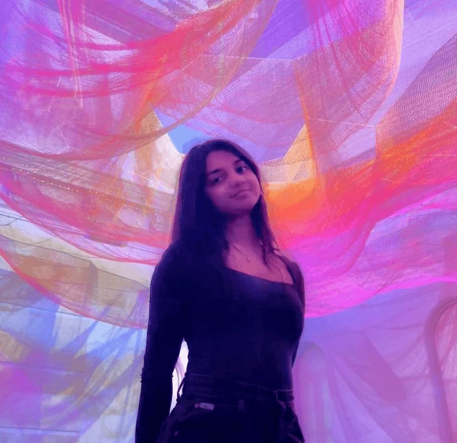 Chrisandra under a colourful textile installation